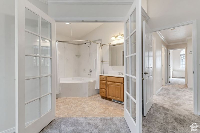 Bathroom with french doors, ornamental molding, vanity, and tile flooring