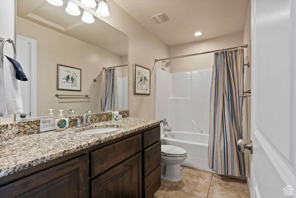 Full bathroom with shower / tub combo, toilet, tile flooring, and vanity