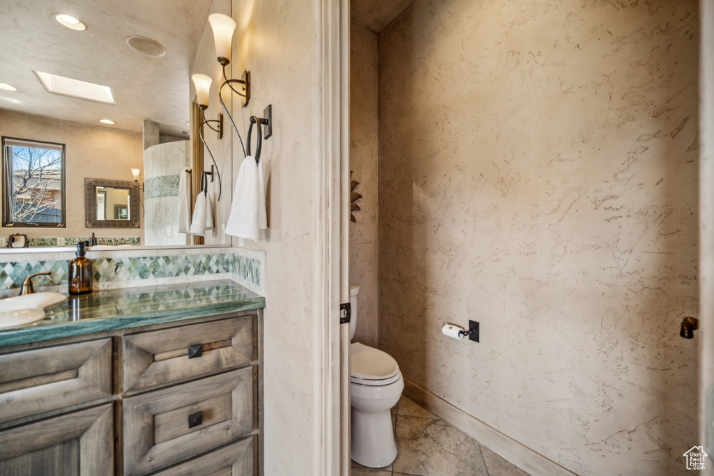 Bathroom with vanity, tile flooring, and toilet