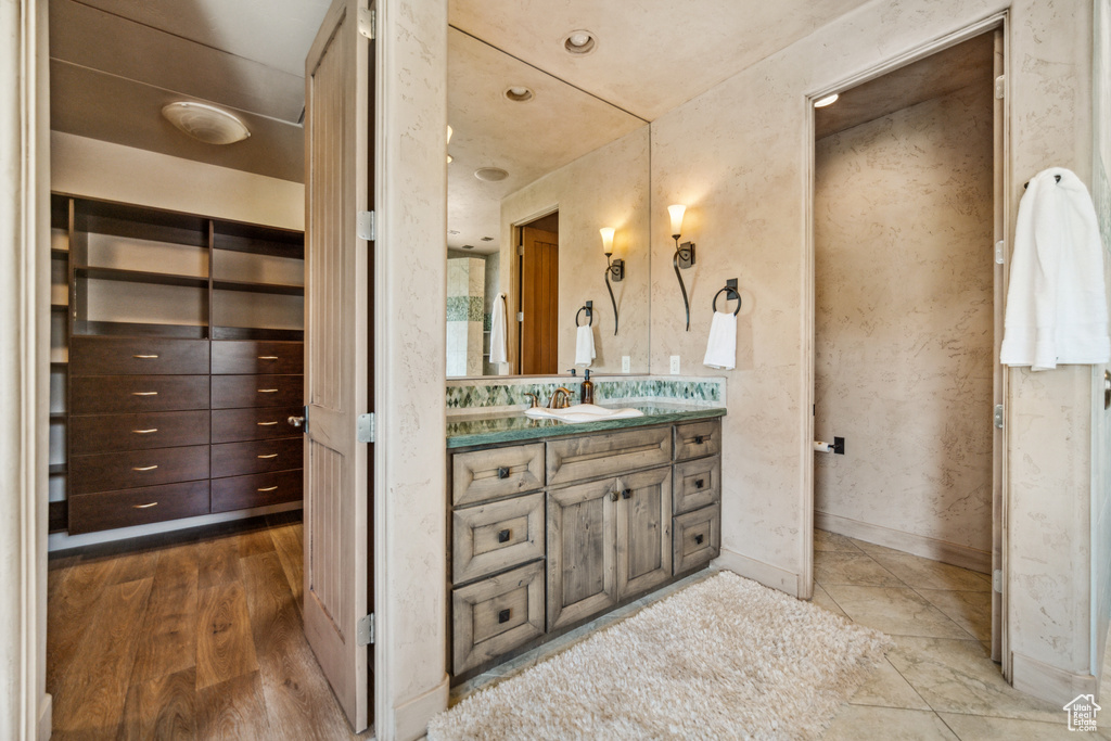 Bathroom with wood-type flooring and oversized vanity