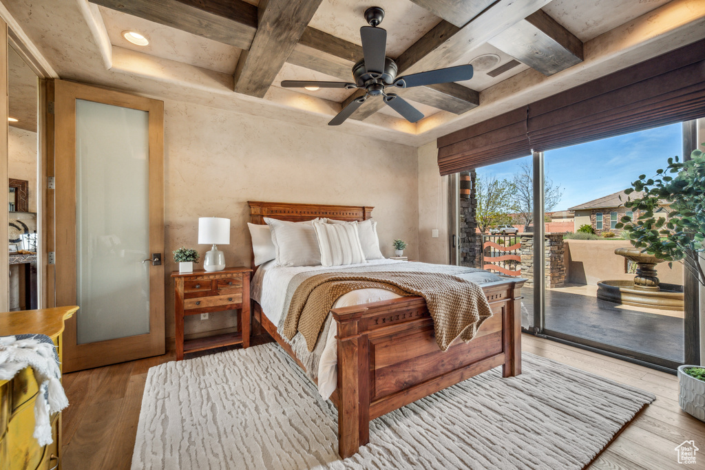 Bedroom featuring light hardwood / wood-style flooring, ceiling fan, access to outside, and beamed ceiling