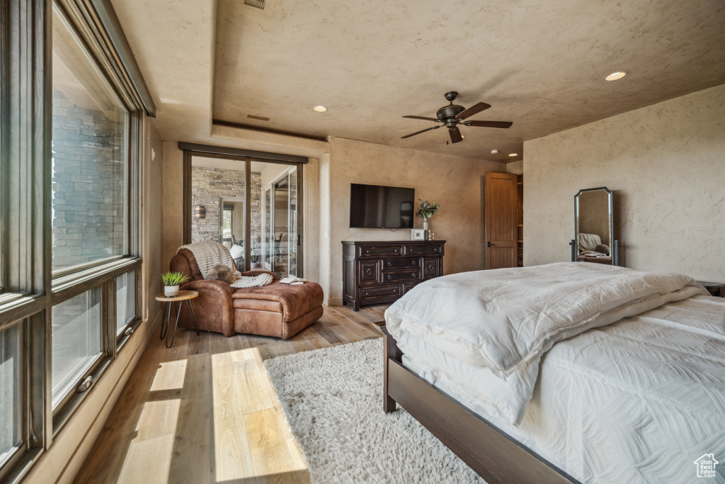 Bedroom with access to exterior, ceiling fan, and light wood-type flooring