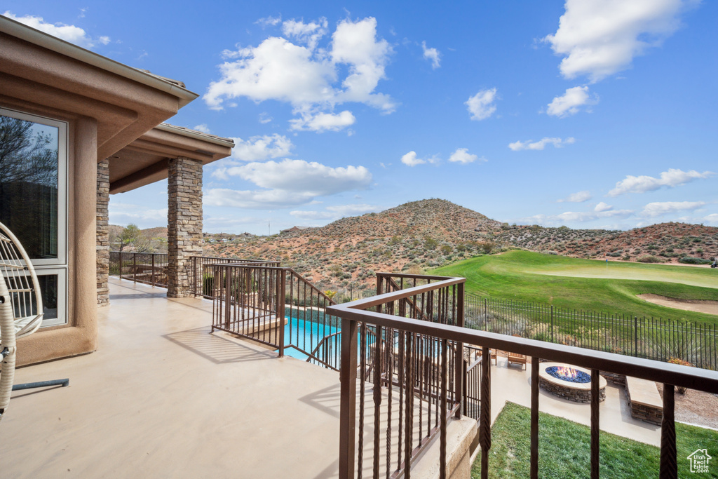 Balcony with a patio, a fenced in pool, and a mountain view