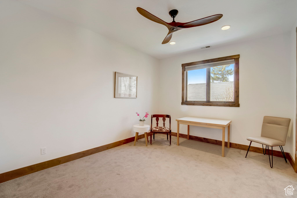 Sitting room featuring ceiling fan and light colored carpet