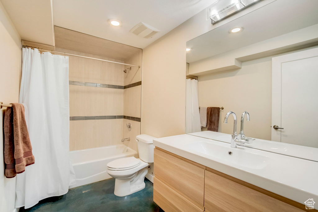 Full bathroom with shower / tub combo, vanity, and toilet