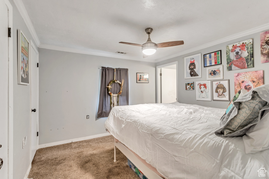 Bedroom with dark colored carpet, crown molding, and ceiling fan