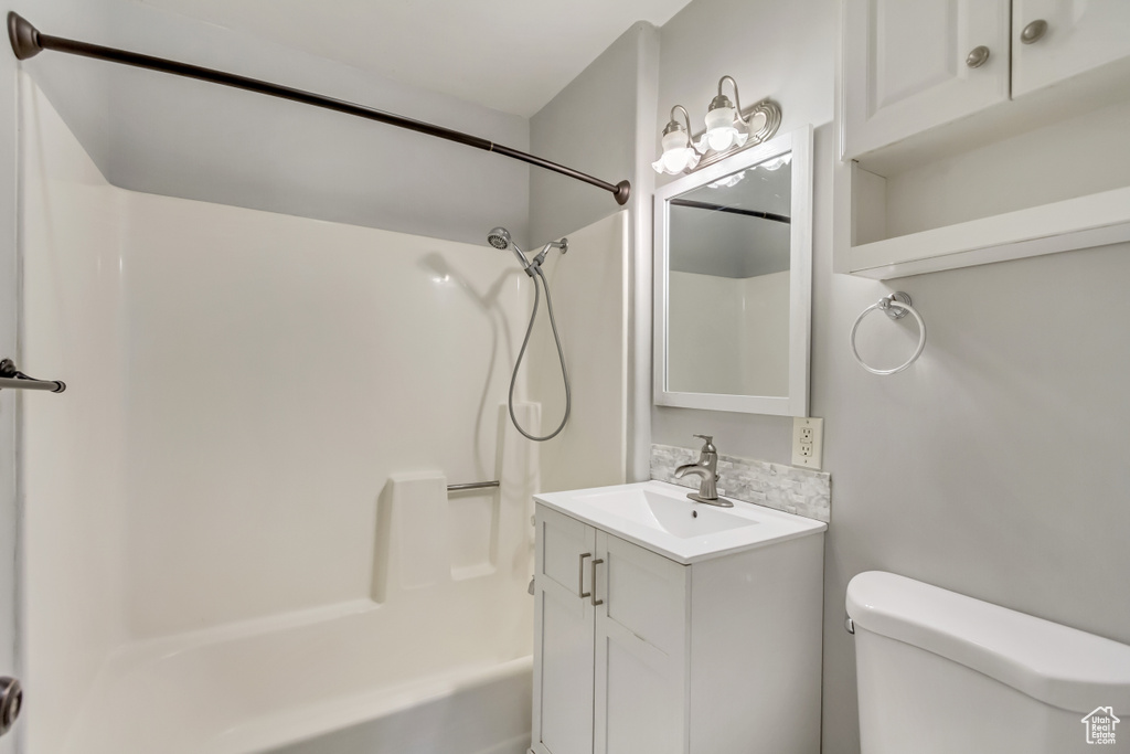 Full bathroom featuring vanity,  shower combination, and toilet