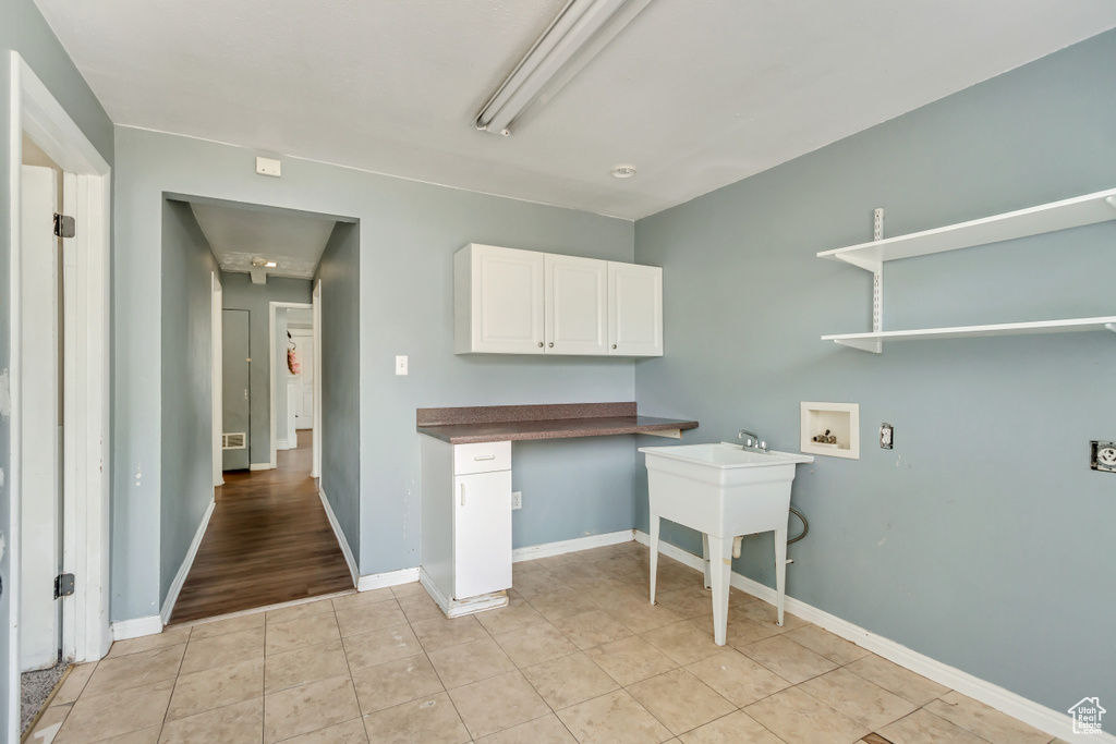 Kitchen featuring white cabinets and light tile patterned floors