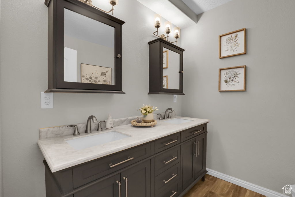 Bathroom with hardwood / wood-style floors and dual bowl vanity