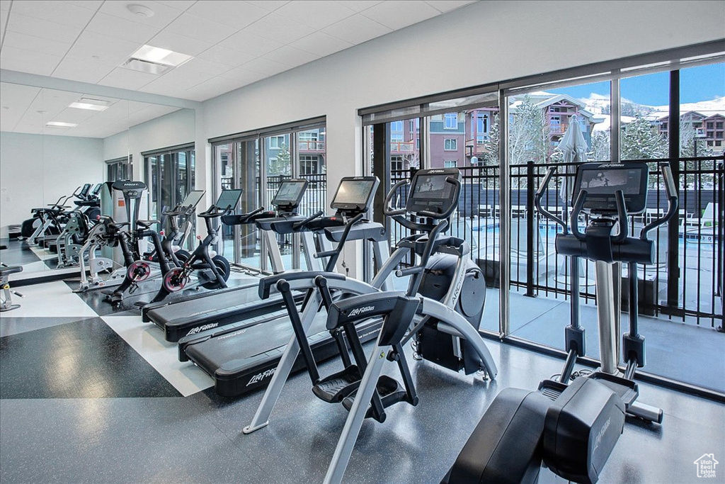 Workout area with plenty of natural light and a drop ceiling