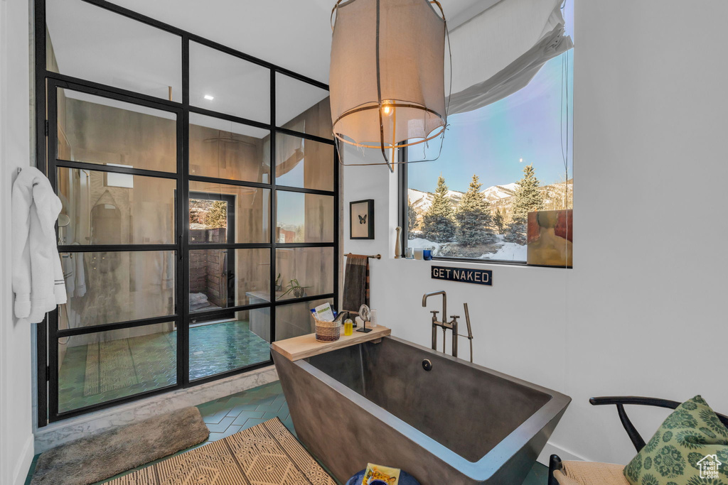 Bathroom featuring an inviting chandelier and tile floors