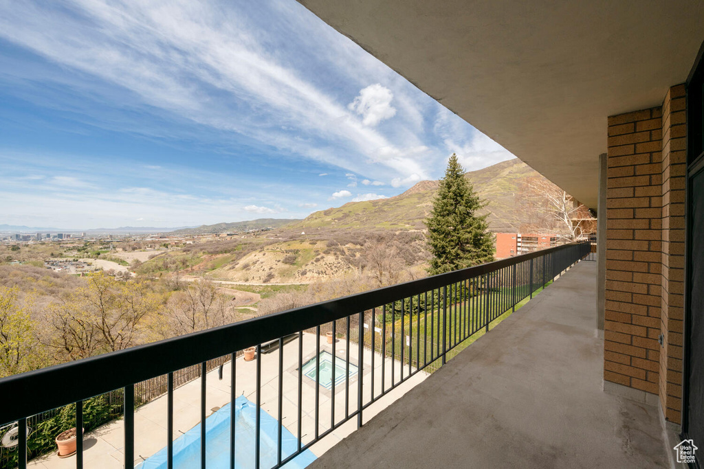 Balcony with a fenced in pool and a mountain view