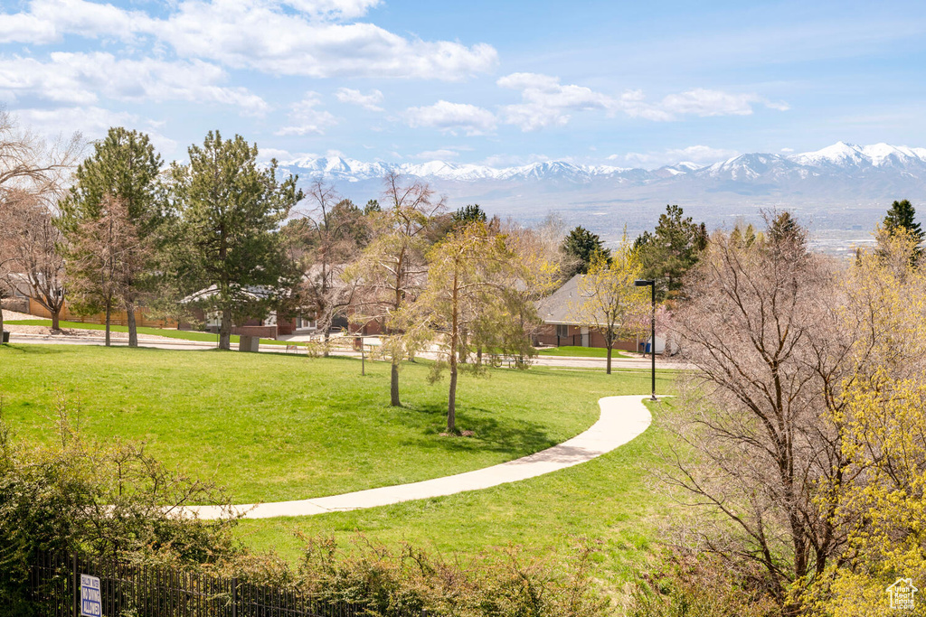 Surrounding community featuring a mountain view and a lawn