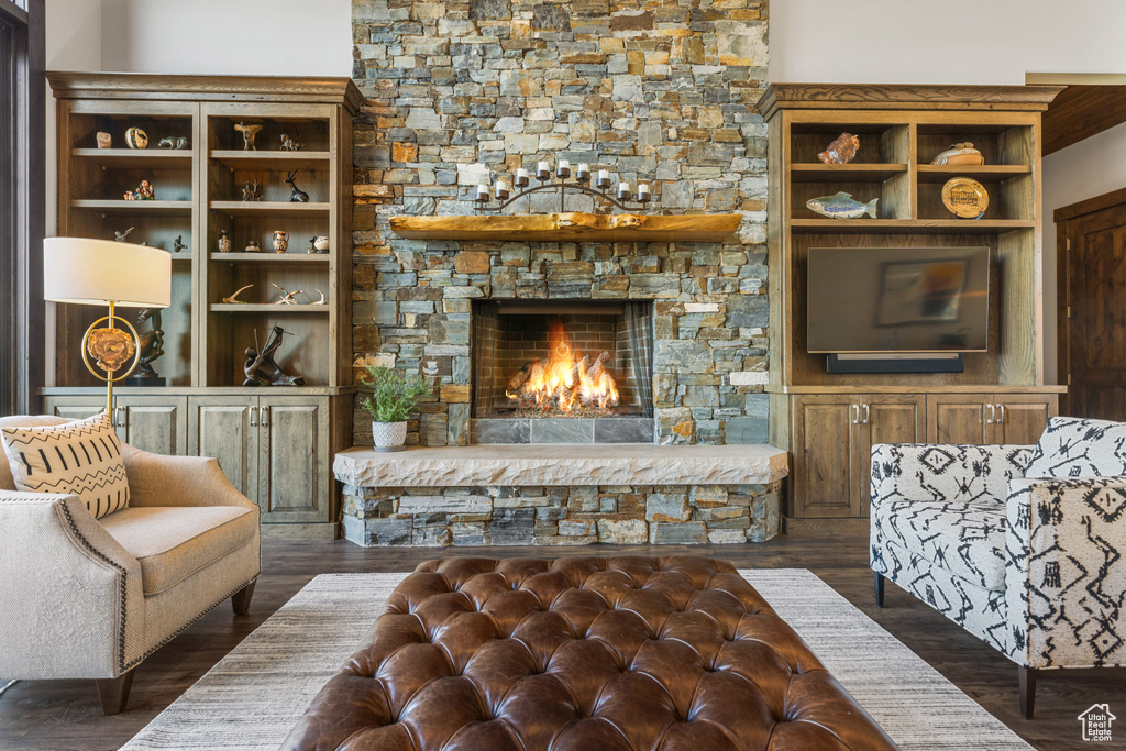 Living room featuring dark hardwood / wood-style floors and a fireplace