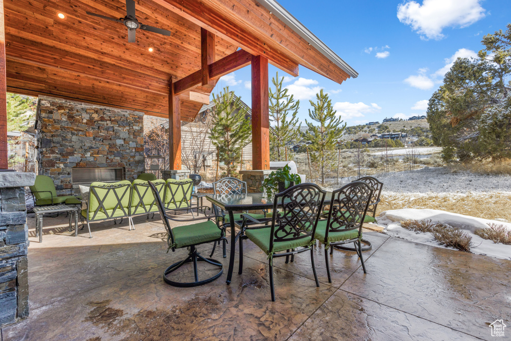 View of patio featuring an outdoor stone fireplace