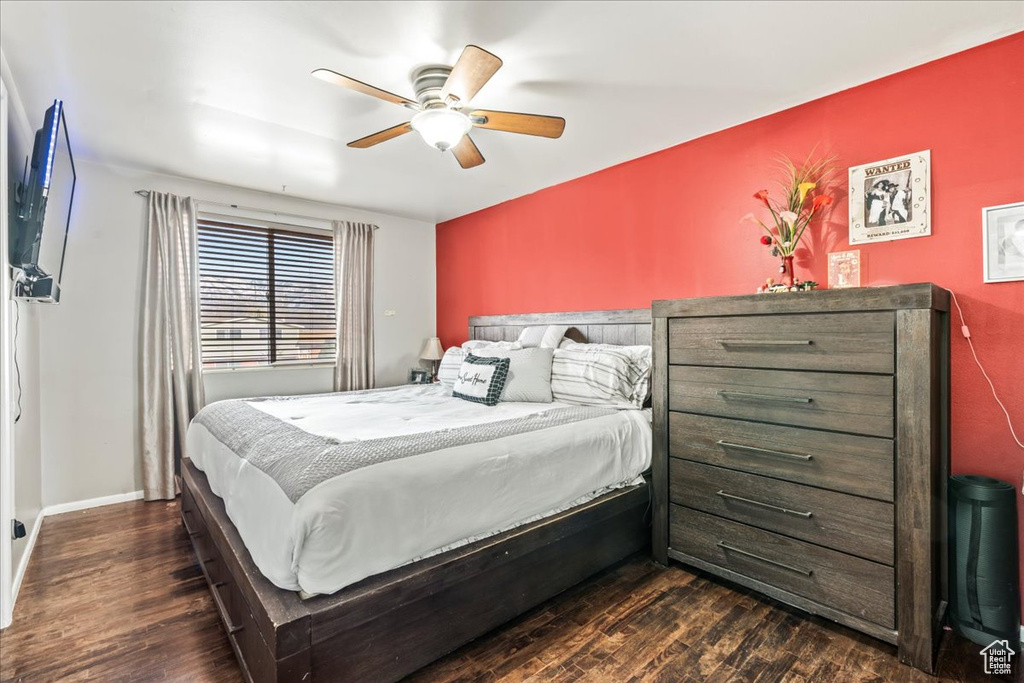 Bedroom featuring dark hardwood / wood-style flooring and ceiling fan