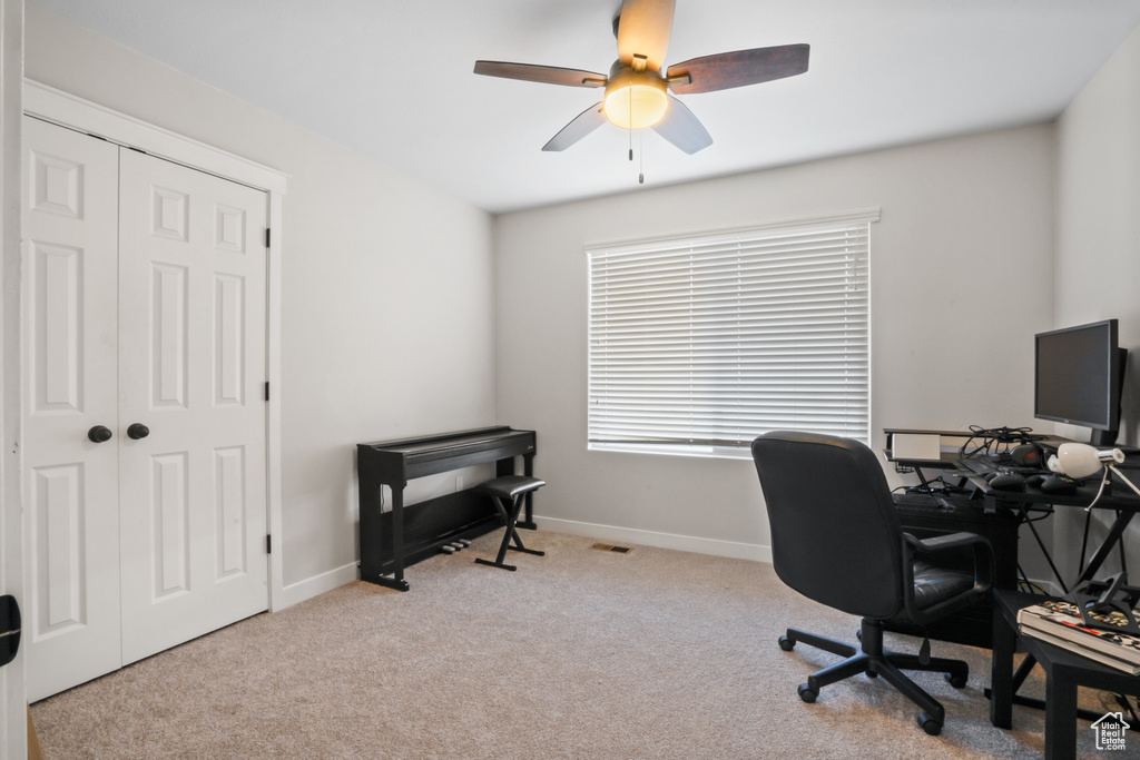 Office with light colored carpet and ceiling fan