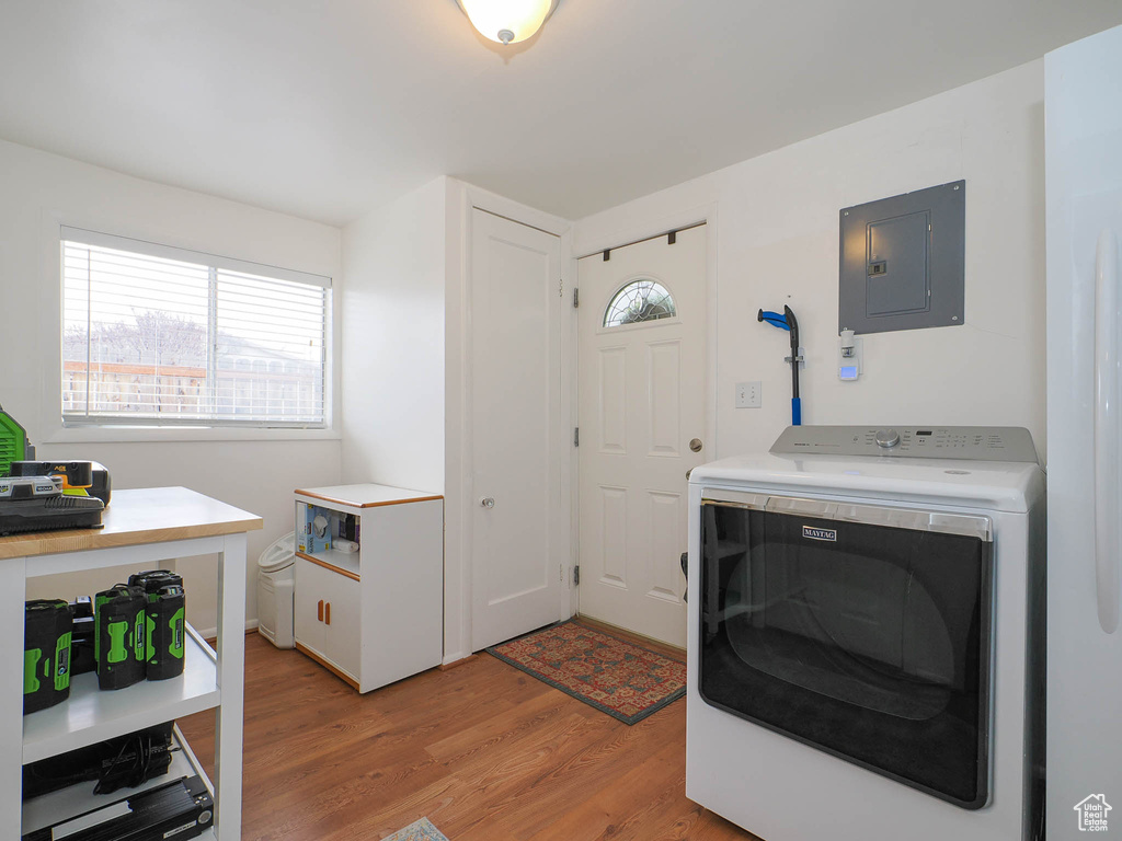 Laundry room with washer / dryer and light wood-type flooring