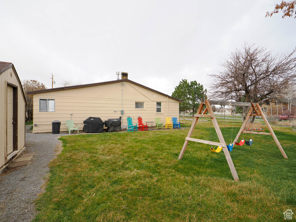 View of yard with a playground and an outdoor structure