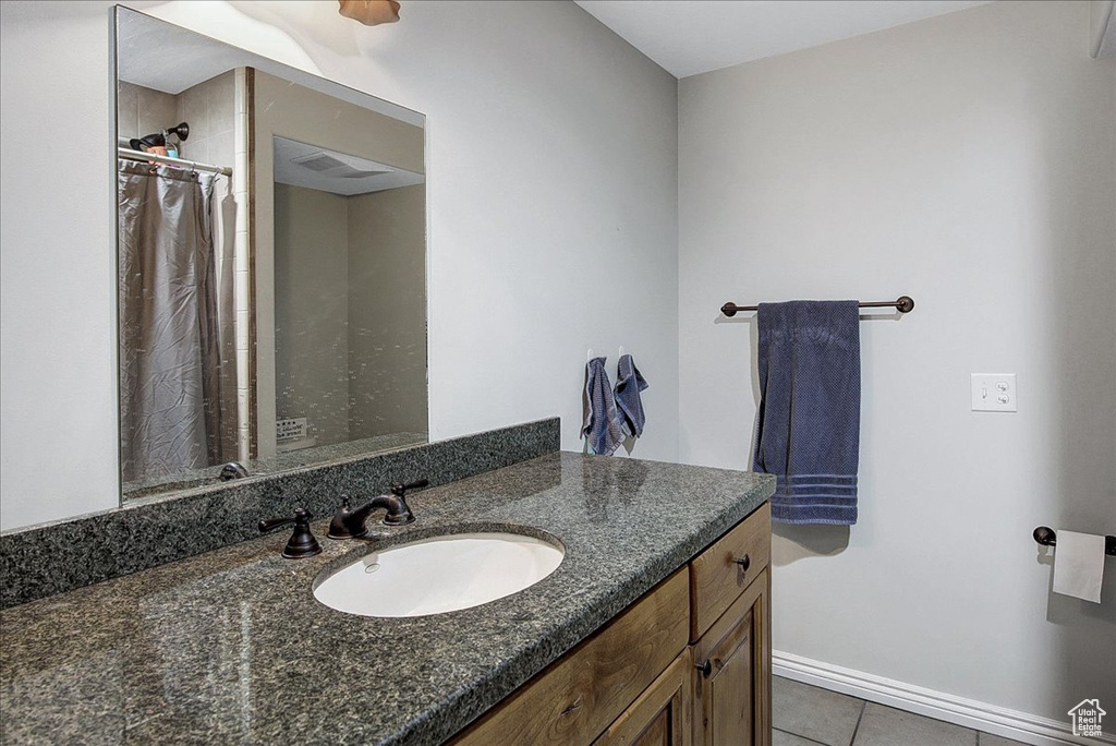 Bathroom with tile floors and vanity with extensive cabinet space