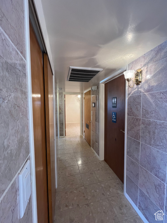 Hallway with light tile floors