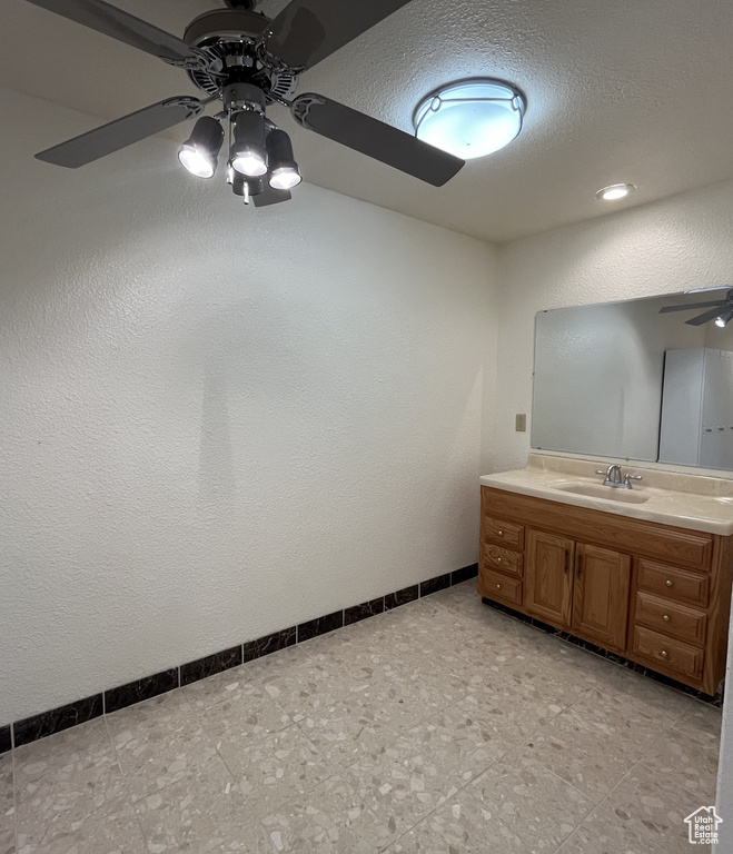 Bathroom with vanity, tile flooring, and ceiling fan