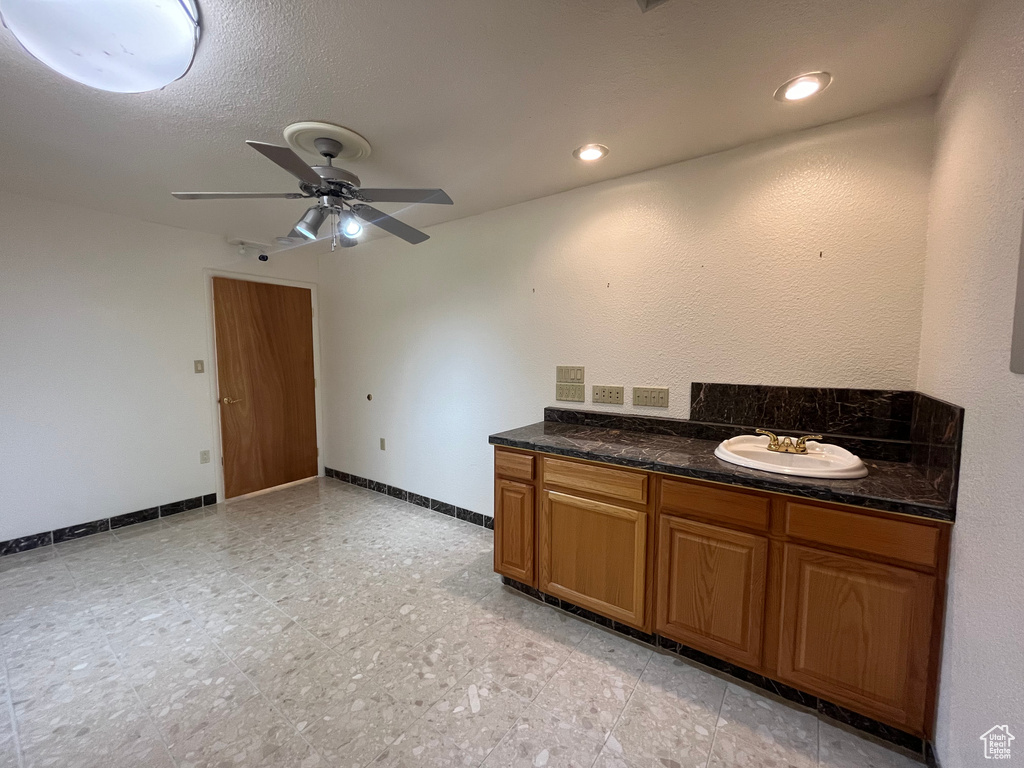 Bathroom featuring tile floors, ceiling fan, and vanity