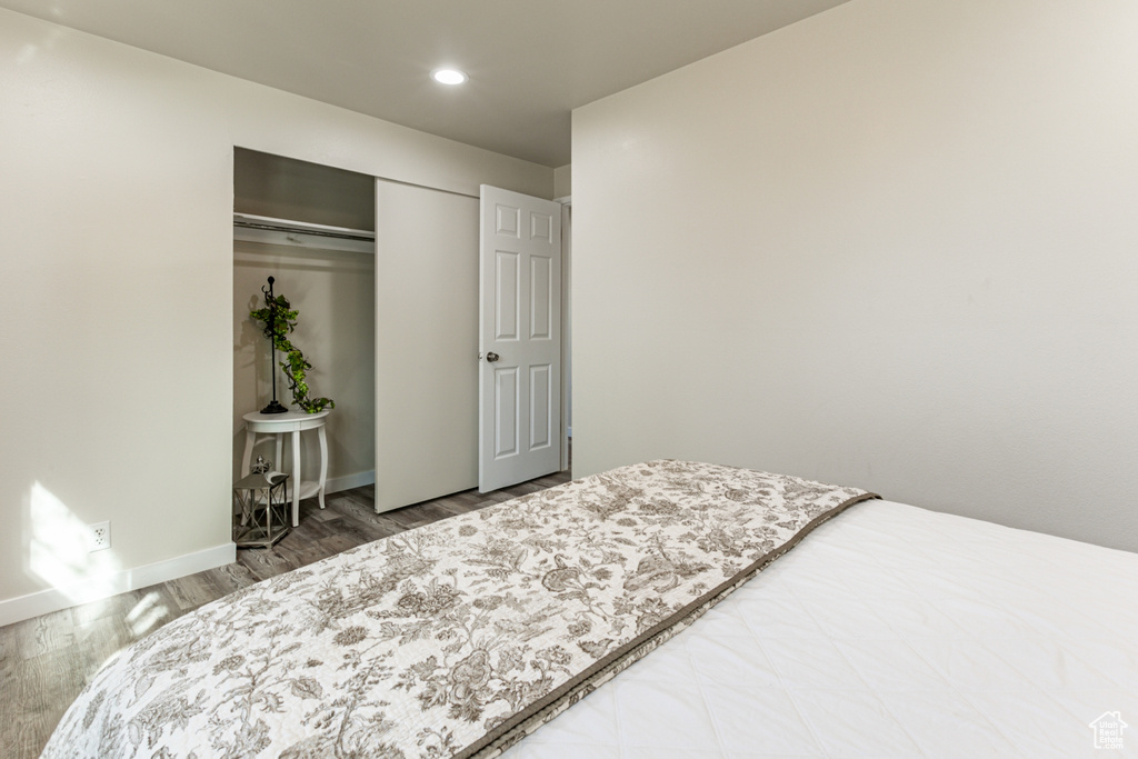 Bedroom featuring a closet and hardwood / wood-style floors