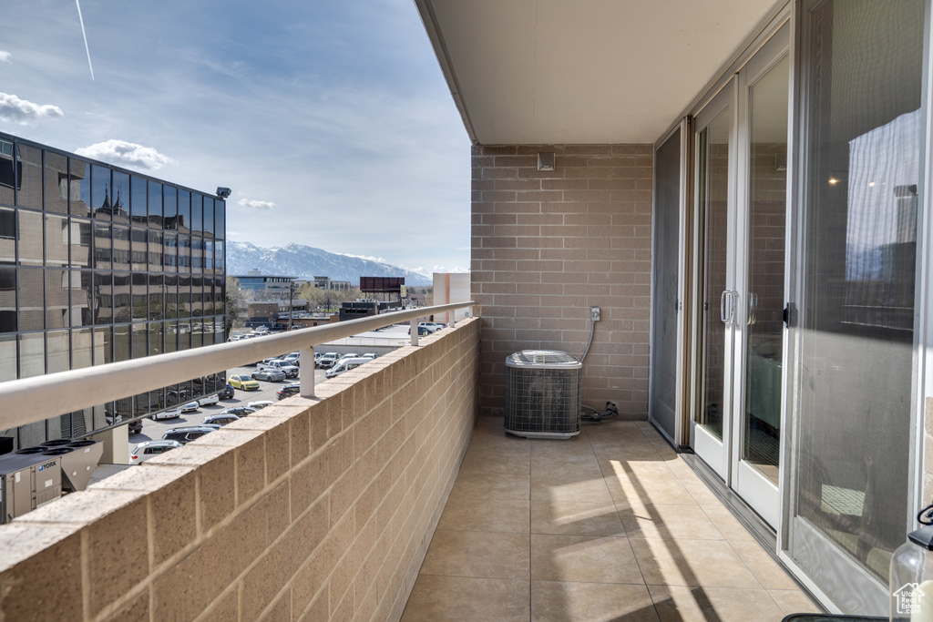 Balcony featuring central AC and a mountain view