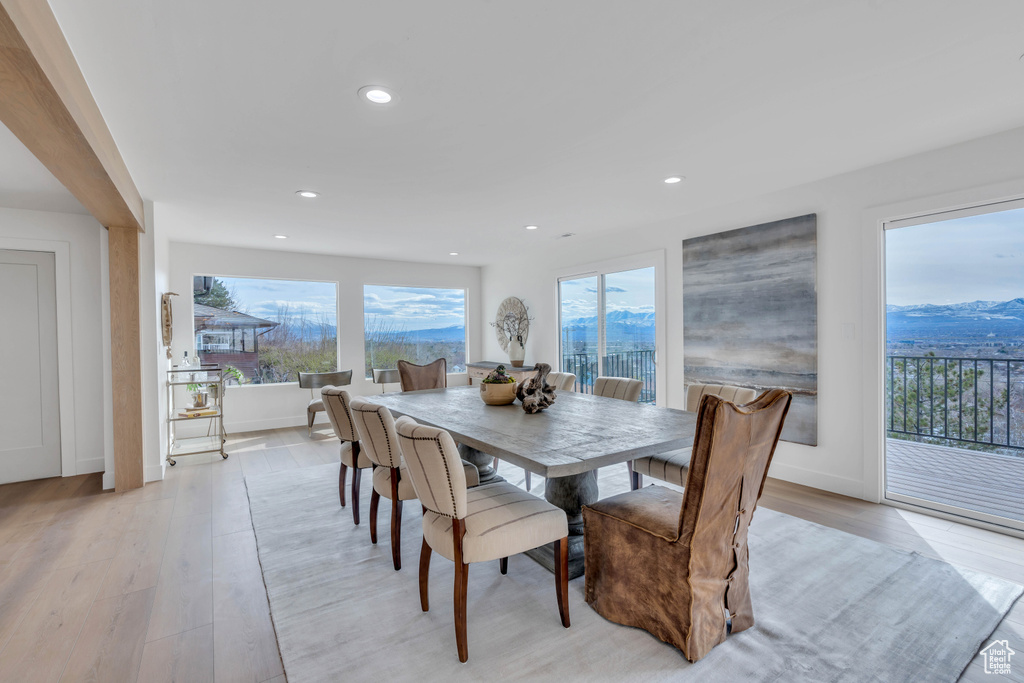 Dining space with a mountain view and light hardwood / wood-style flooring