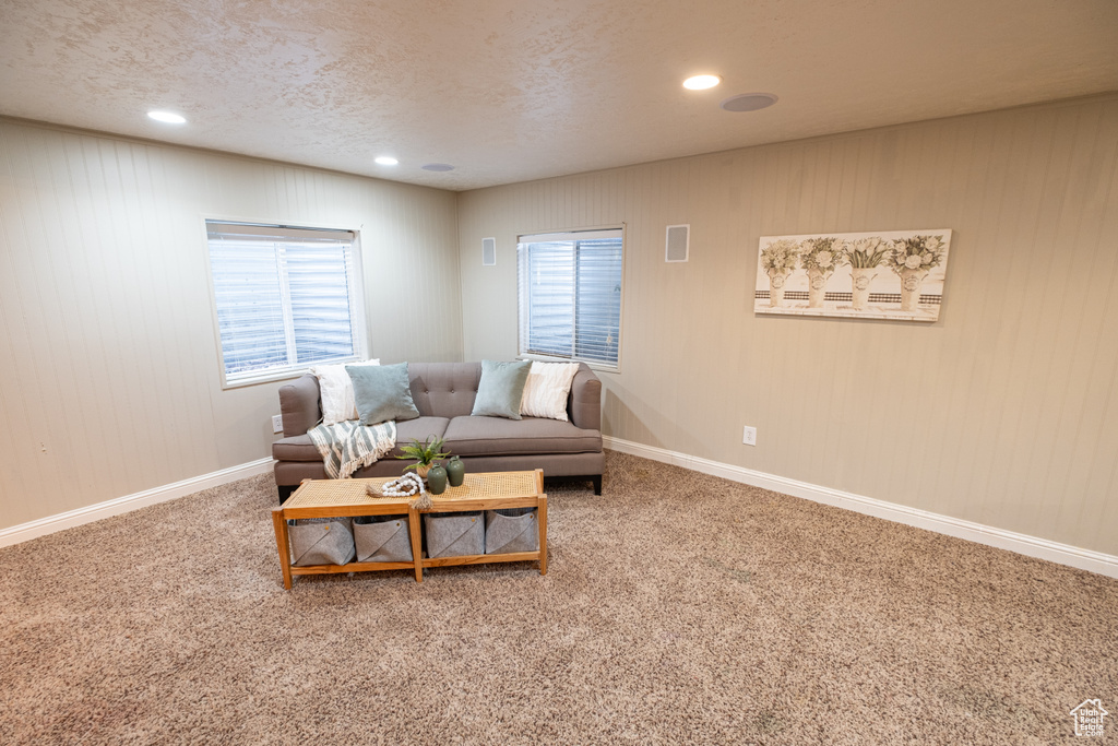 Living room with a textured ceiling and light colored carpet