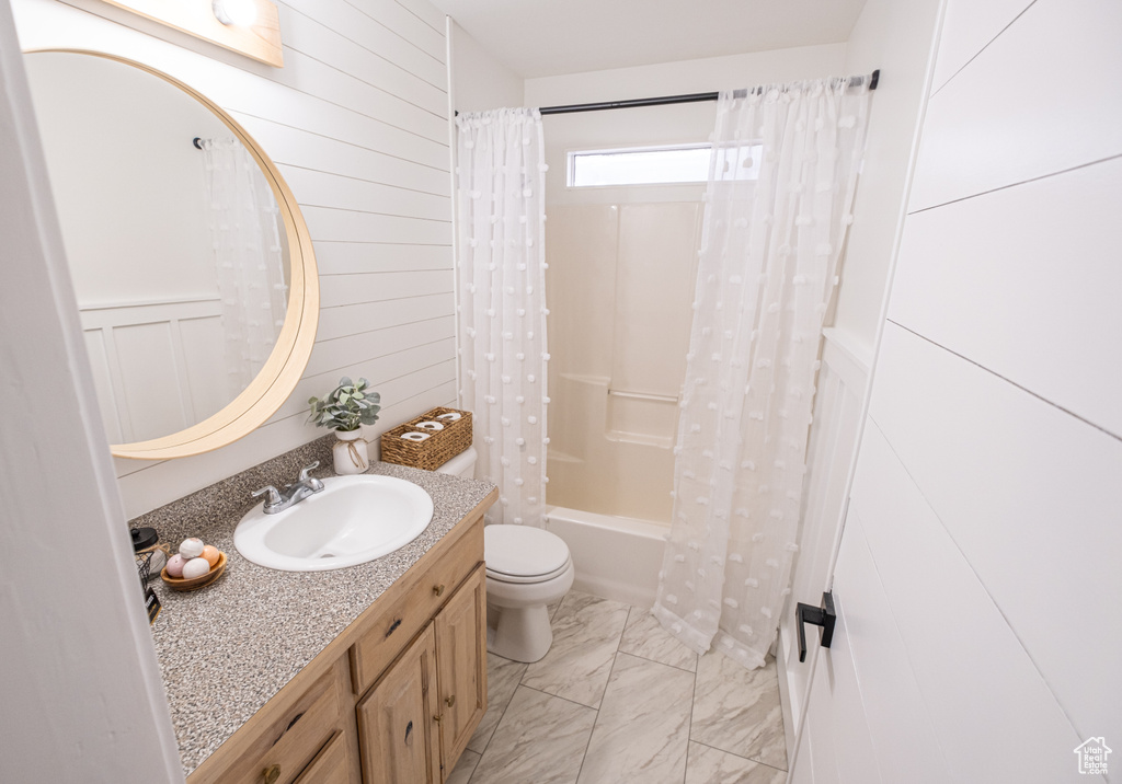 Full bathroom with toilet, vanity, shower / bathtub combination with curtain, and tile flooring