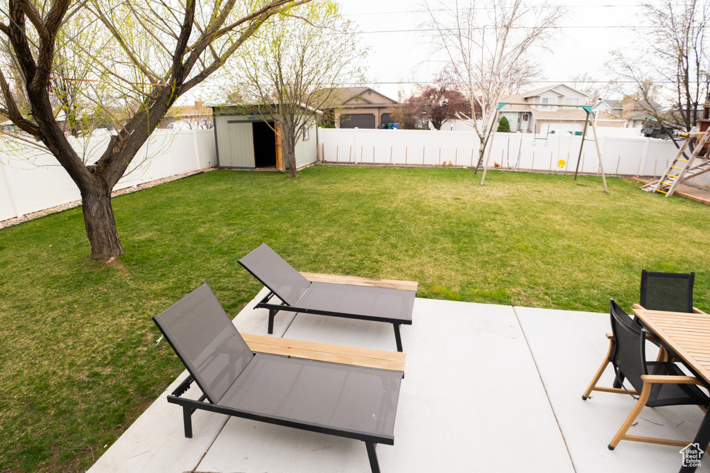 View of yard with a patio and a storage shed