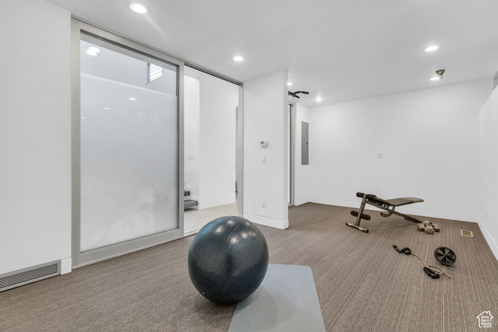 Workout room with light colored carpet