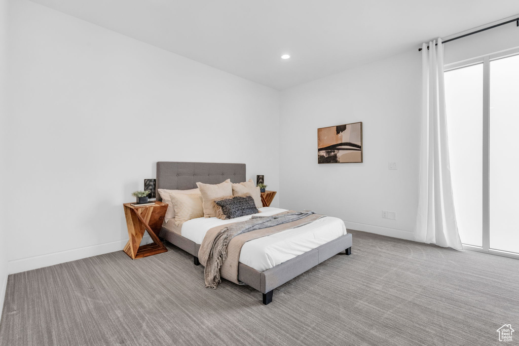 Bedroom featuring light colored carpet