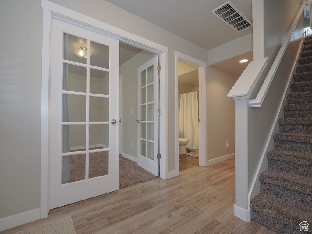 Interior space featuring french doors and light hardwood / wood-style flooring
