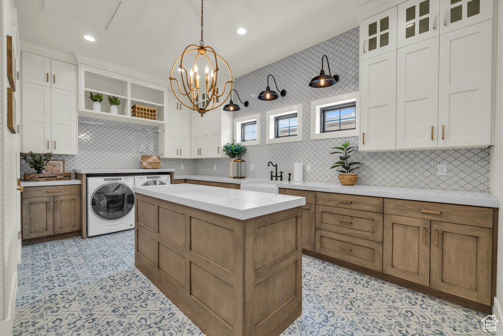 Kitchen with tasteful backsplash, light tile flooring, and white cabinetry