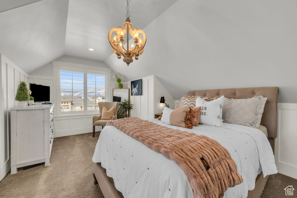 Bedroom with a notable chandelier, light colored carpet, and lofted ceiling