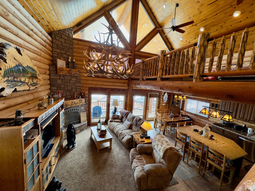 Living room with high vaulted ceiling, beam ceiling, wooden ceiling, rustic walls, and a fireplace