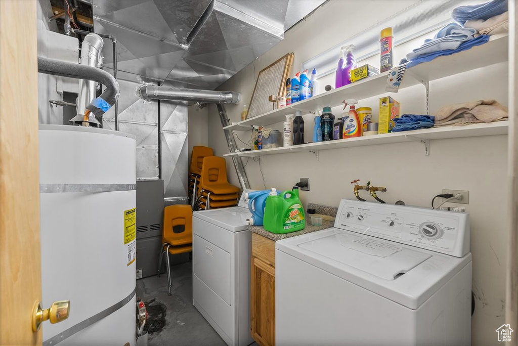 Laundry room with washer hookup, washer and dryer, and secured water heater