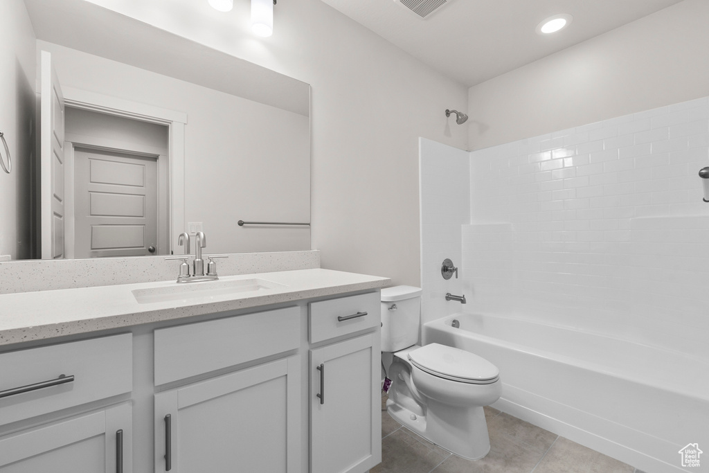 Full bathroom featuring toilet, tile flooring, shower / bath combination, and vanity