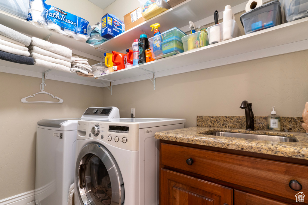 Laundry area featuring washer and clothes dryer and sink