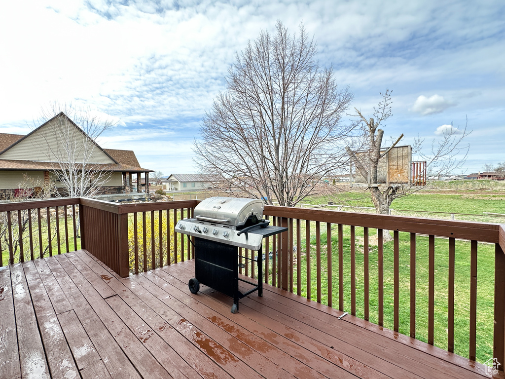 Deck with a yard and a grill