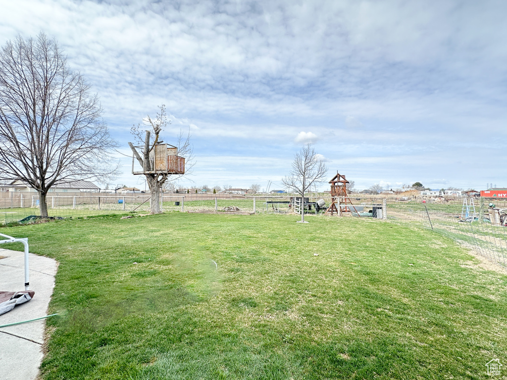 View of yard featuring a playground and a rural view