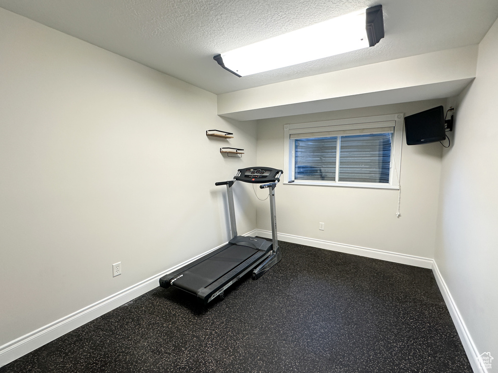 Exercise room with a textured ceiling
