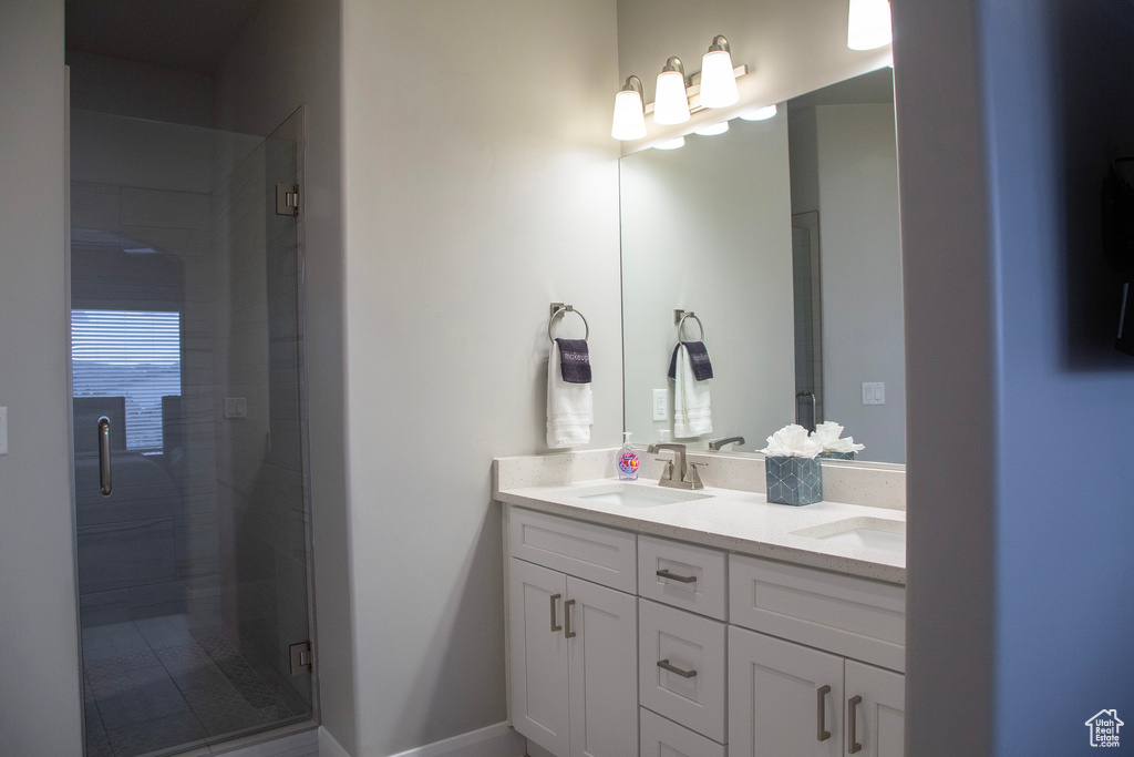 Bathroom with walk in shower and double sink vanity