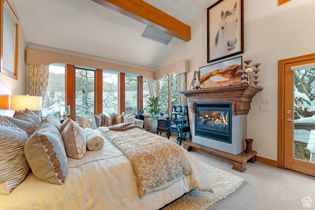 Carpeted bedroom with access to outside and lofted ceiling with beams