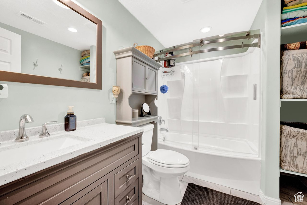 Full bathroom featuring tile flooring, vanity with extensive cabinet space, shower / bathing tub combination, and toilet