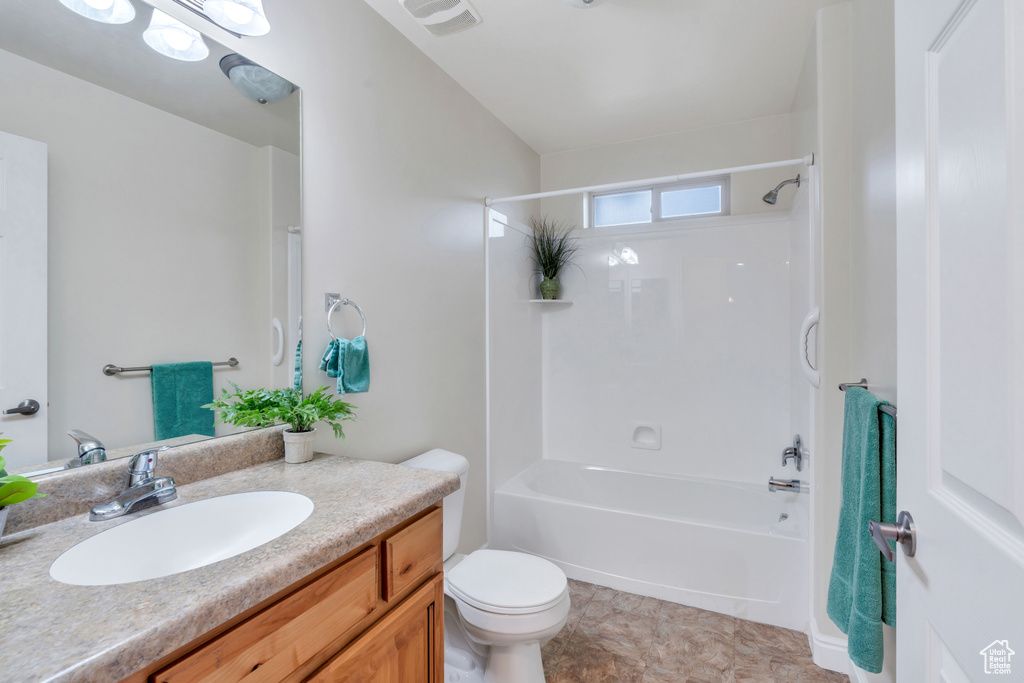 Full bathroom with shower / tub combination, toilet, tile floors, and oversized vanity