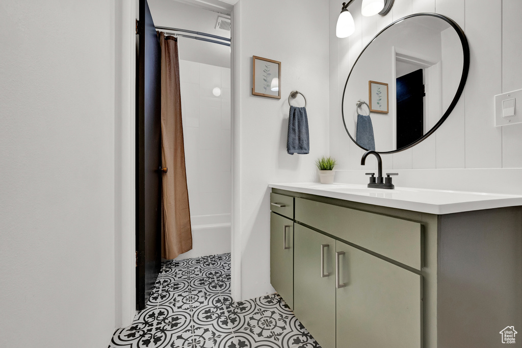 Bathroom featuring shower / bath combo, tile floors, and vanity